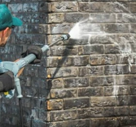 man is washing the brick wall